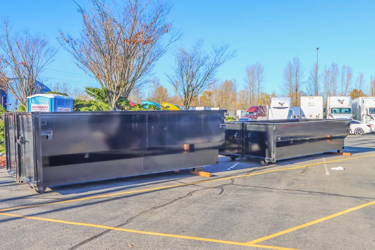 Professional dumpster rental service with roll-off container on residential driveway in Eatonton